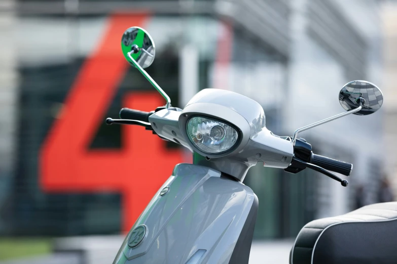 a moped parked on the street in front of a building