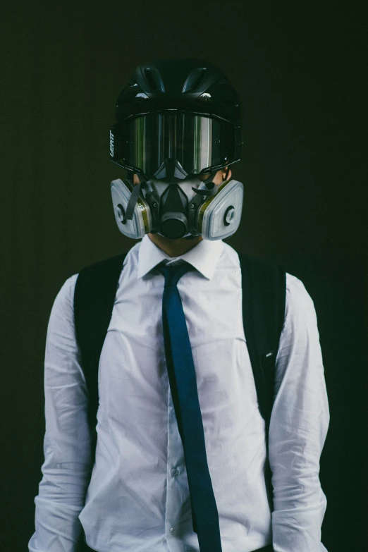 a man with a gas mask on his face wearing a tie