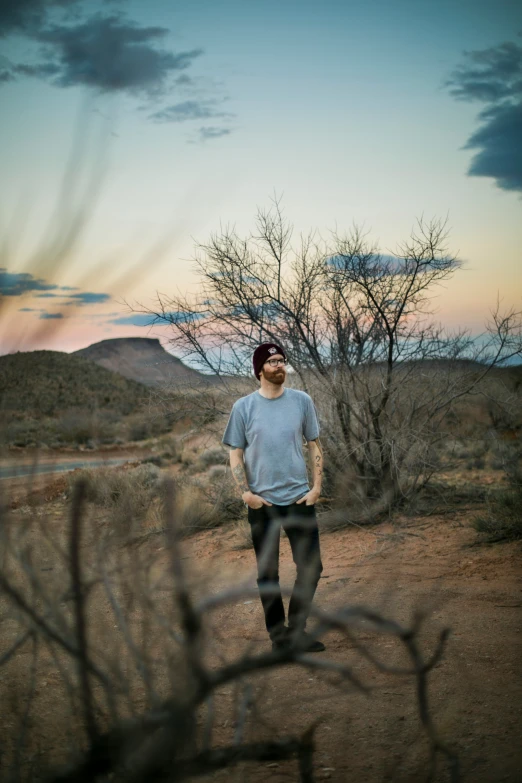 a man is standing in the middle of a field