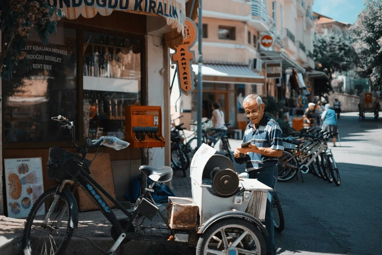 an older man driving a small moped down the street