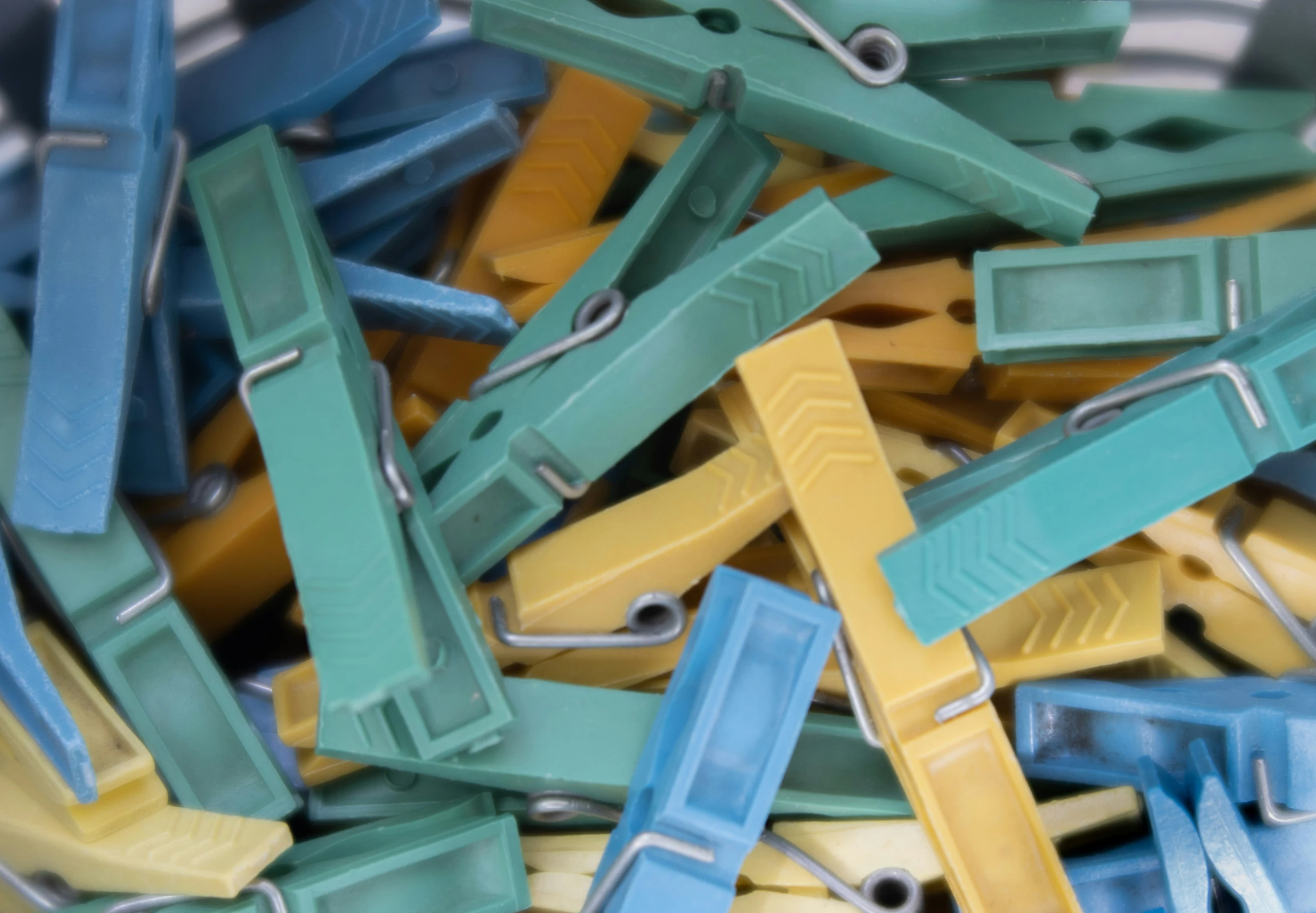 a pile of clothes pins sitting on top of a white plate