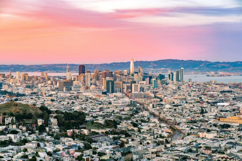 an aerial view of a city, with hills in the background