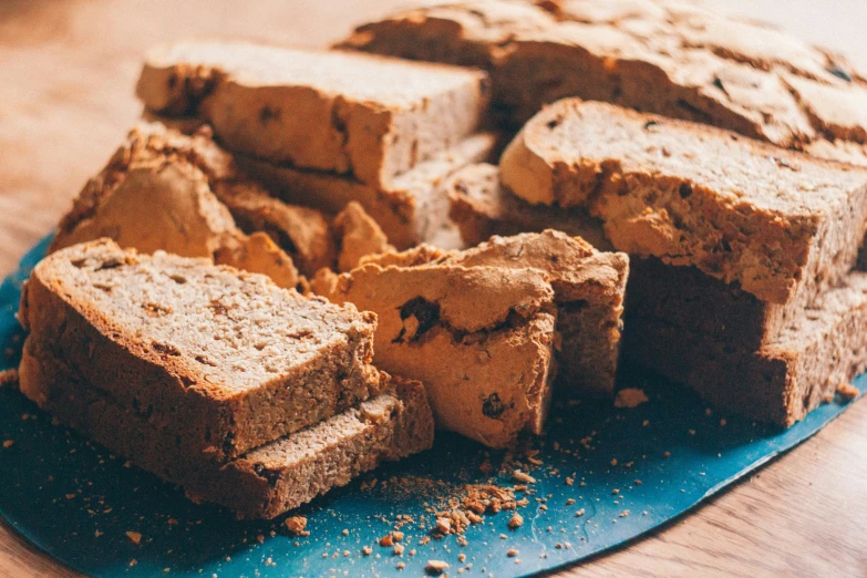 pieces of bread on a plate and another cut up piece