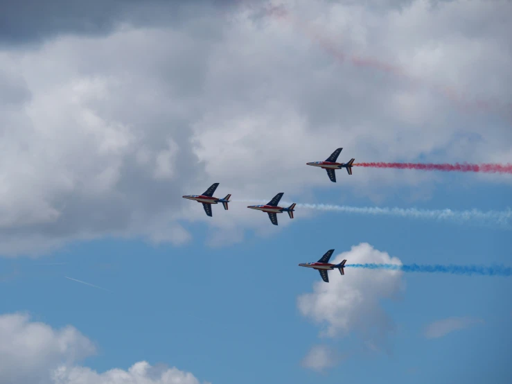 four airplanes are flying in formation in the sky