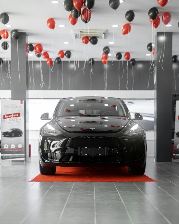 a modern car with balloons floating from the ceiling