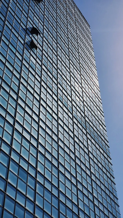 a very tall building has many glass panels