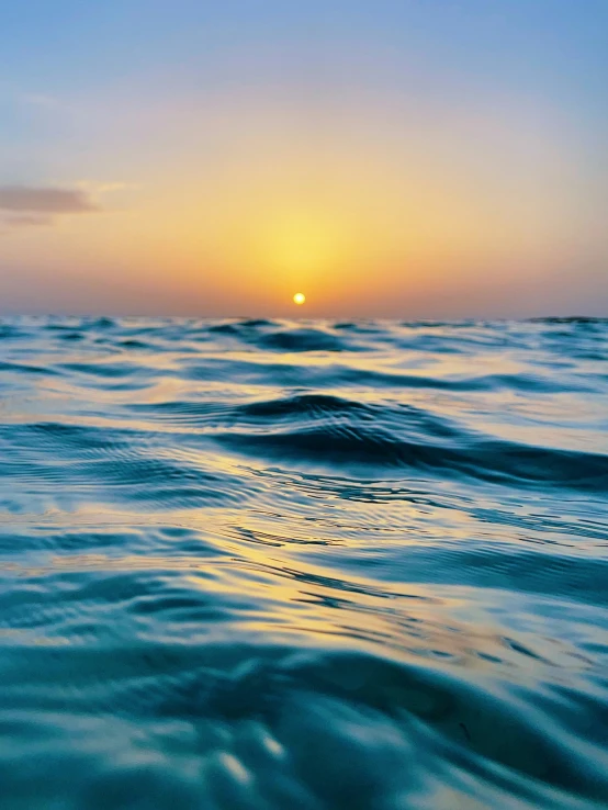 sunset and ripple on water at ocean with sky