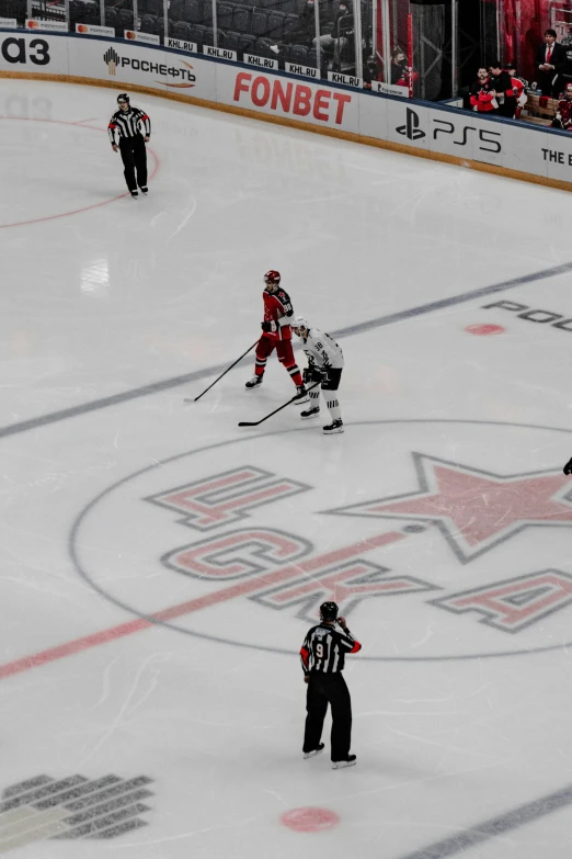 an ice rink with several hockey players on it