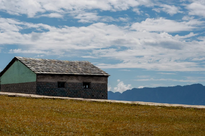 a black and green building on a hill