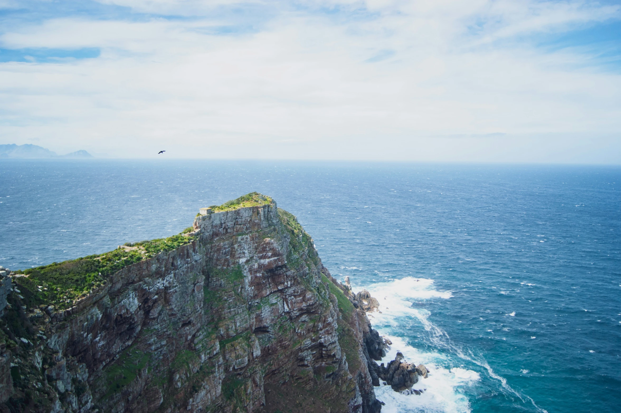 the view from a cliff at the ocean