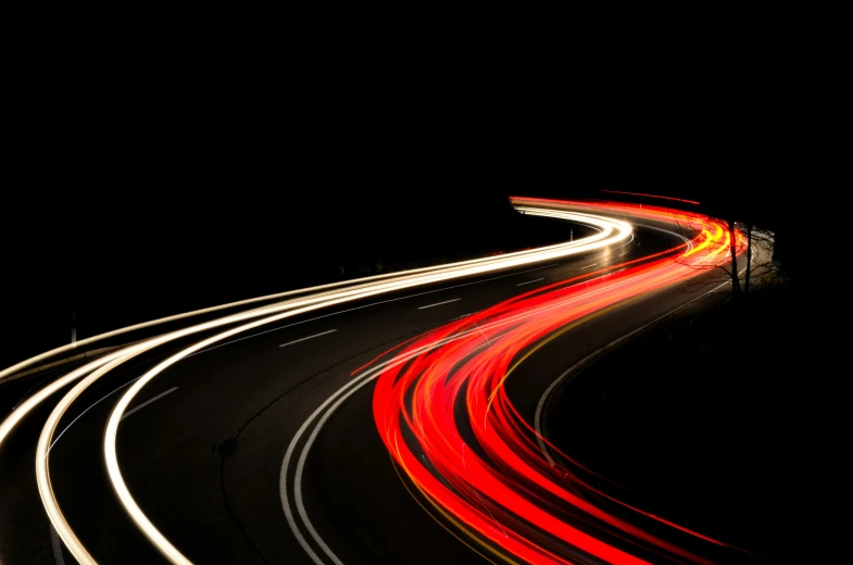 a city street at night with light streaks on it