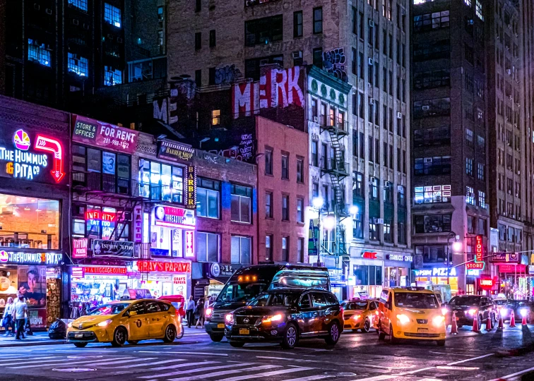 a city street filled with traffic next to tall buildings