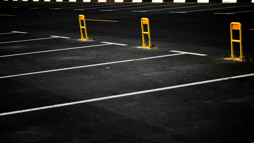 parking spaces lined up with poles and yellow posts