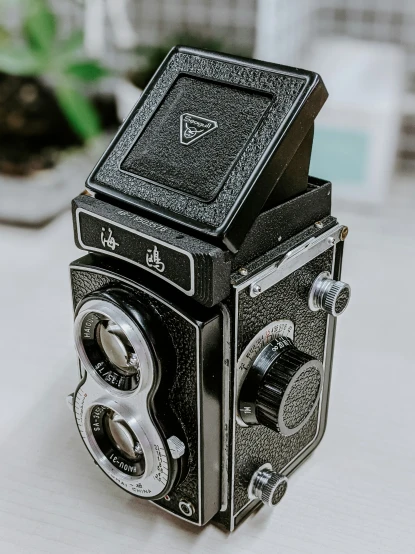 a old black film camera on a table