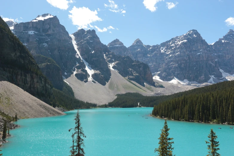 a body of water surrounded by trees and mountains