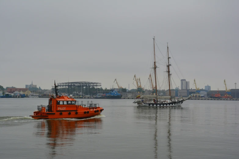 a tug boat and tugboat pulling out of the bay