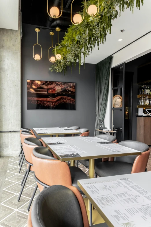 a restaurant with grey walls and orange chairs