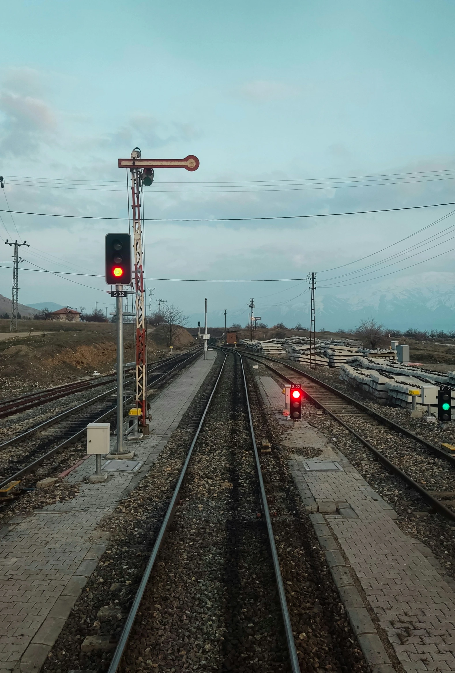 two railroad tracks with one red light on each side