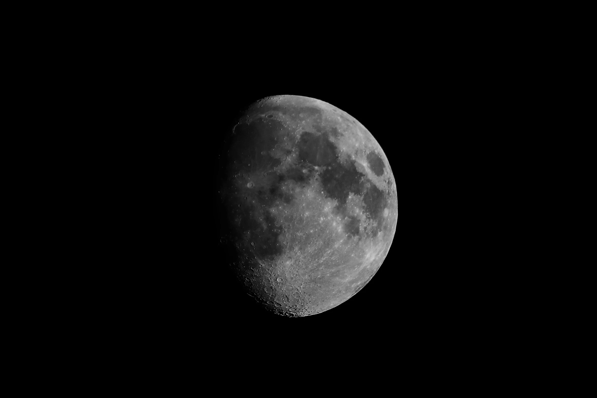 a full moon is seen against a dark sky