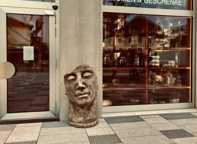 a statue is standing outside of a store