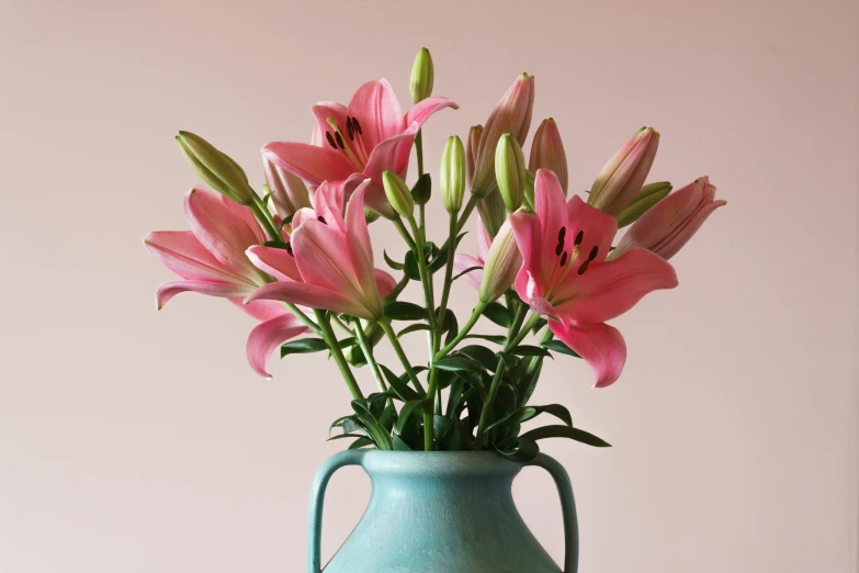 this is a blue vase with flowers in it