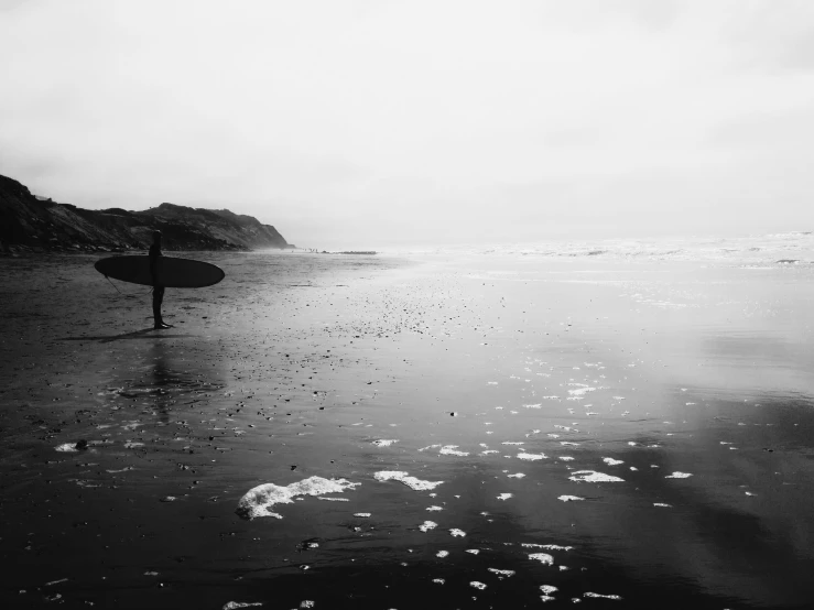 a man on the beach with his surf board