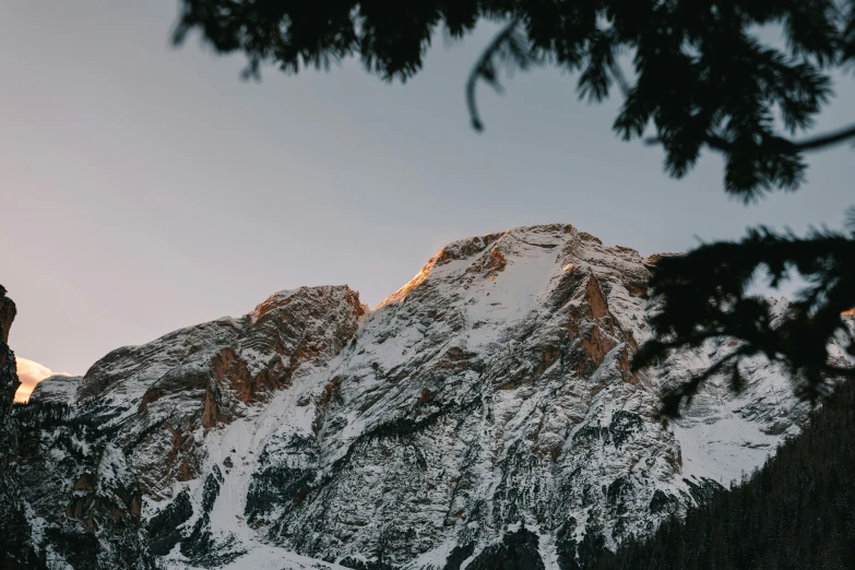 a mountain with snow on the top and a sky