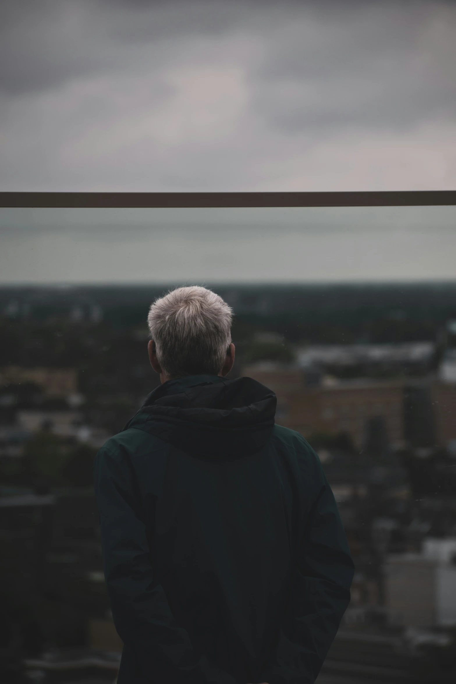 an older man looking out over an urban area