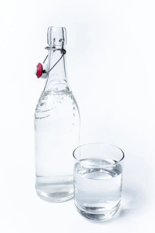 a bottle and a glass on a white background