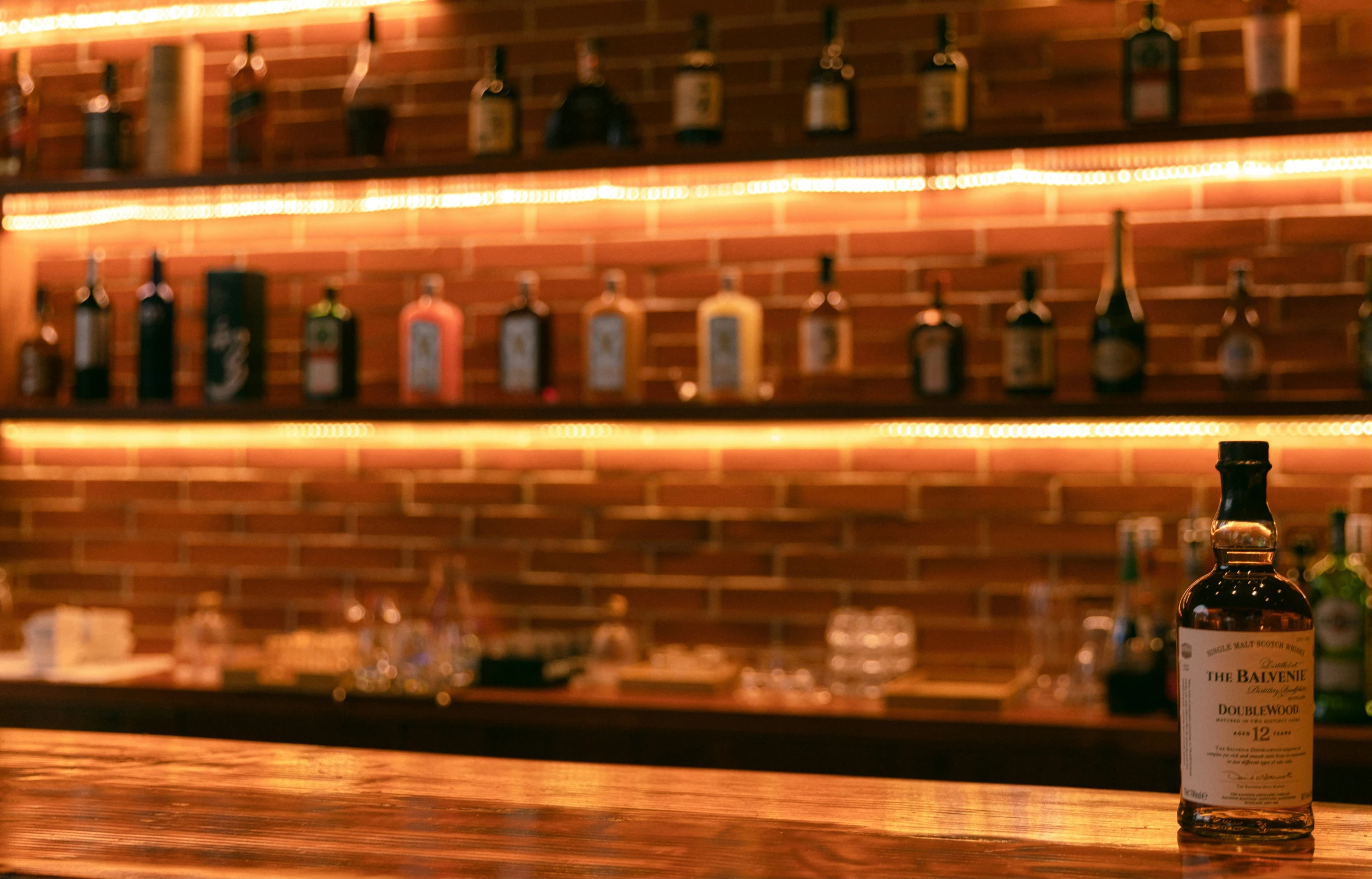 a counter top with bottles on it in front of shelves