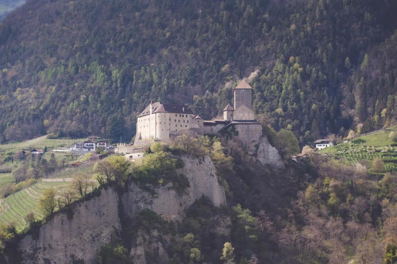 a castle built on the side of a mountain overlooking the valley