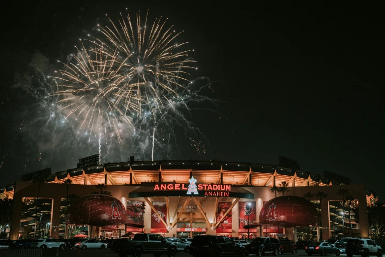 fireworks are lit up in the sky above a stadium