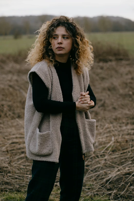 a woman is in the middle of an empty field