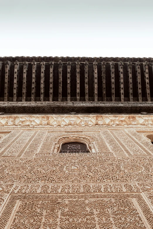 an ornate tower with a small window near it