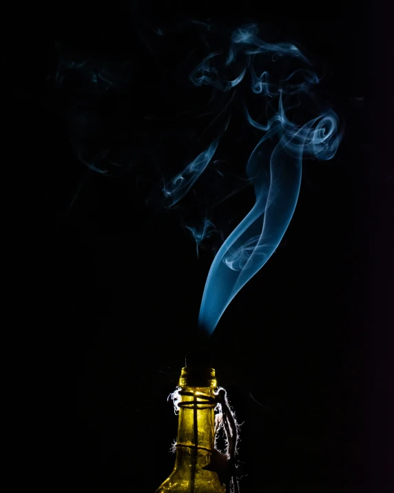 the smoke is flowing from a yellow bottle