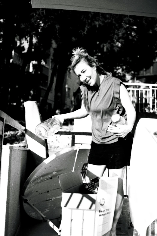 a woman carrying some boxes filled with items