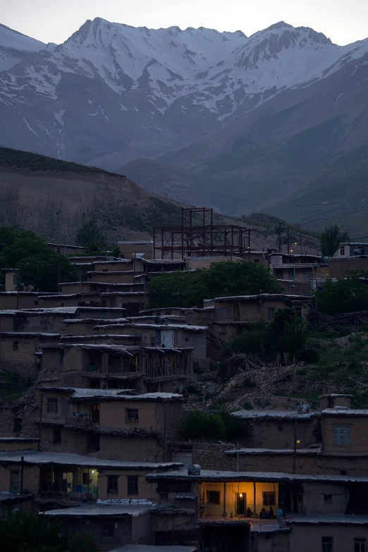 there are houses with a snowy mountain in the background