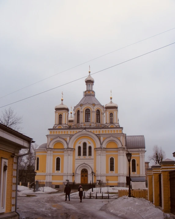 a church is pictured with people in the courtyard