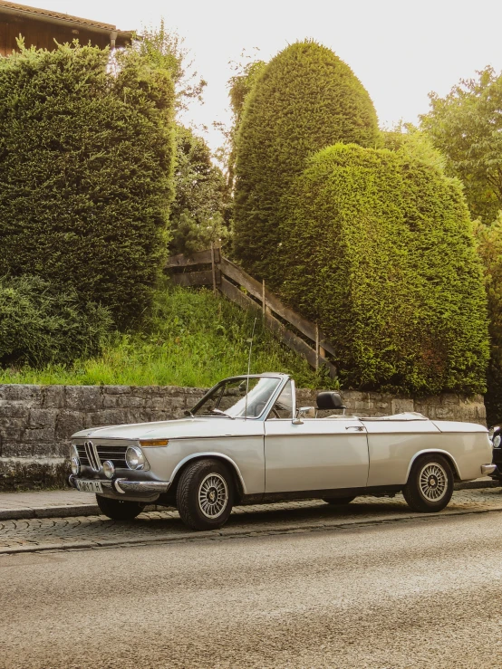 a classic car parked on the side of a street