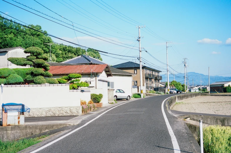 an empty street leading to a small village