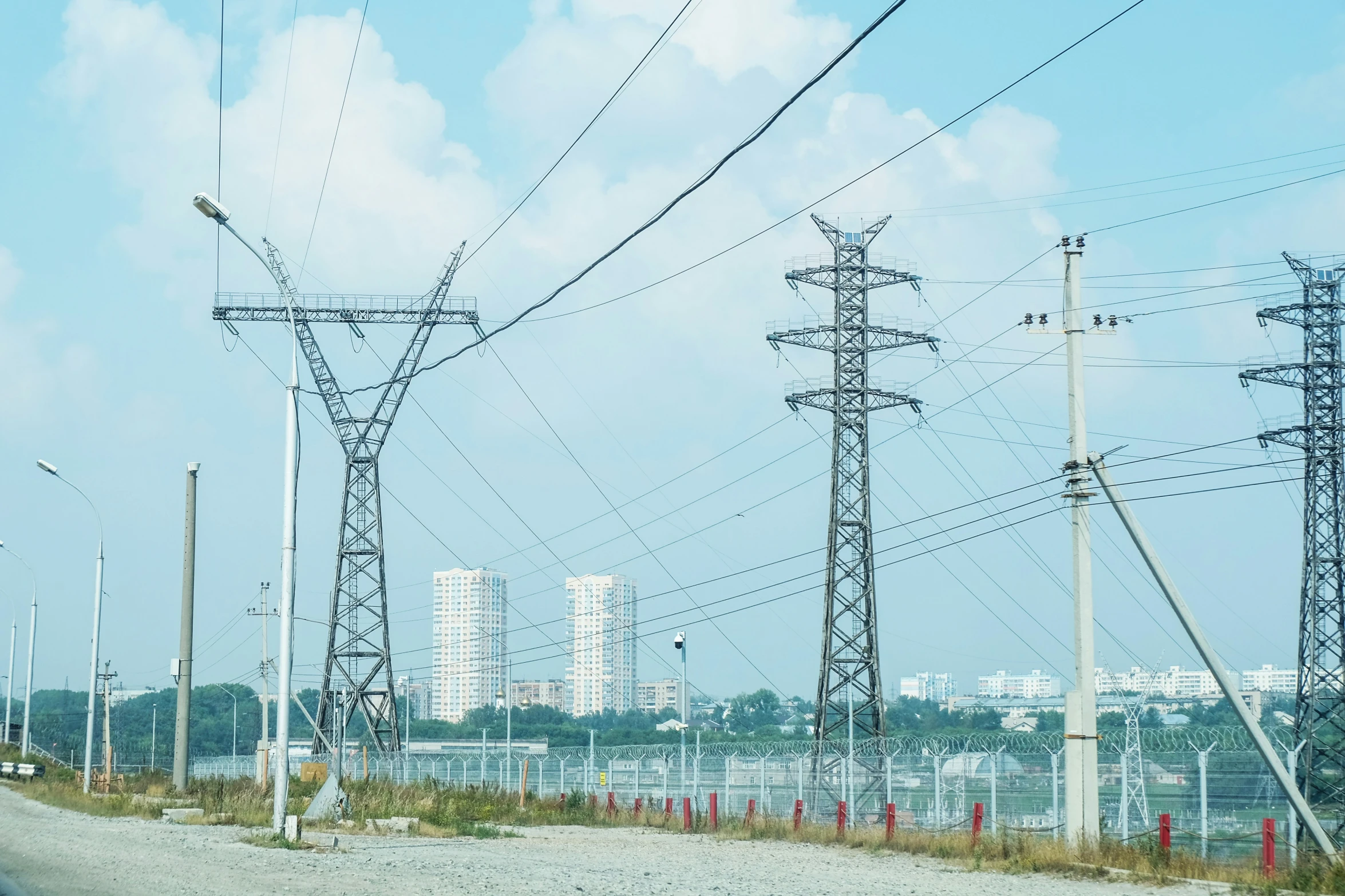 electric power lines with tall buildings in the background