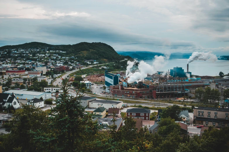 an industrial complex overlooking the town and water