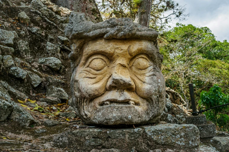 the stone face has been carved to look like it's coming out of the water