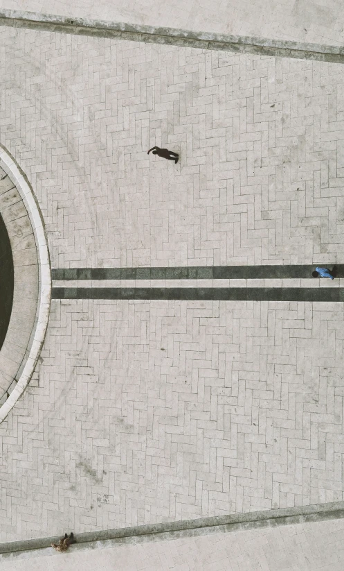 an overhead view of a building, a person and a bench