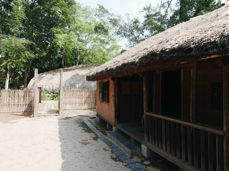 a small building made of mud with trees around it