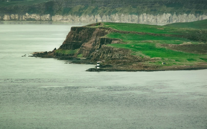 some large mountains on a body of water