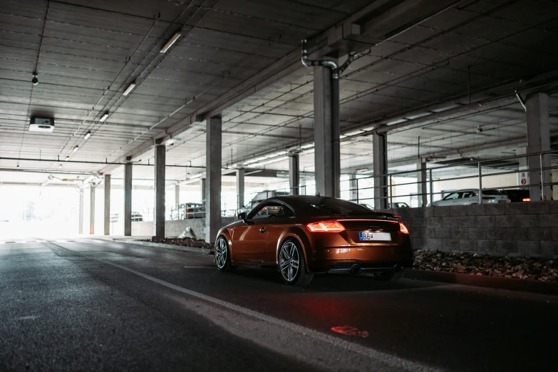 a car sits parked next to an underpass