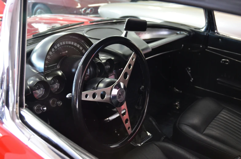 a vintage sports car sitting inside of a showroom