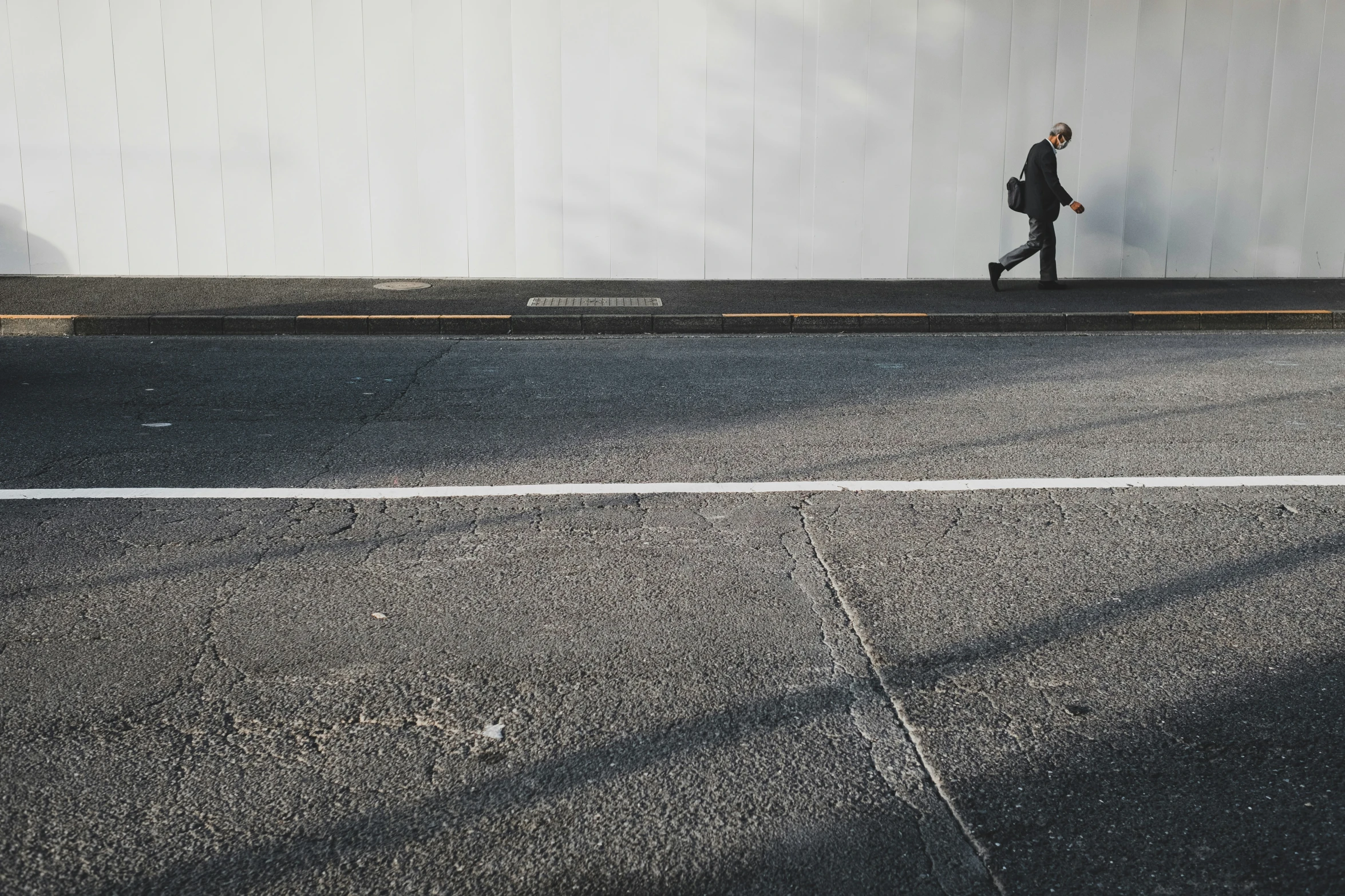 a man walking down the side of a road