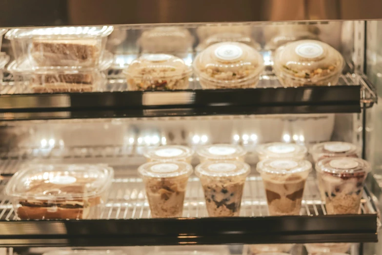 an assortment of cakes and ice creams on display